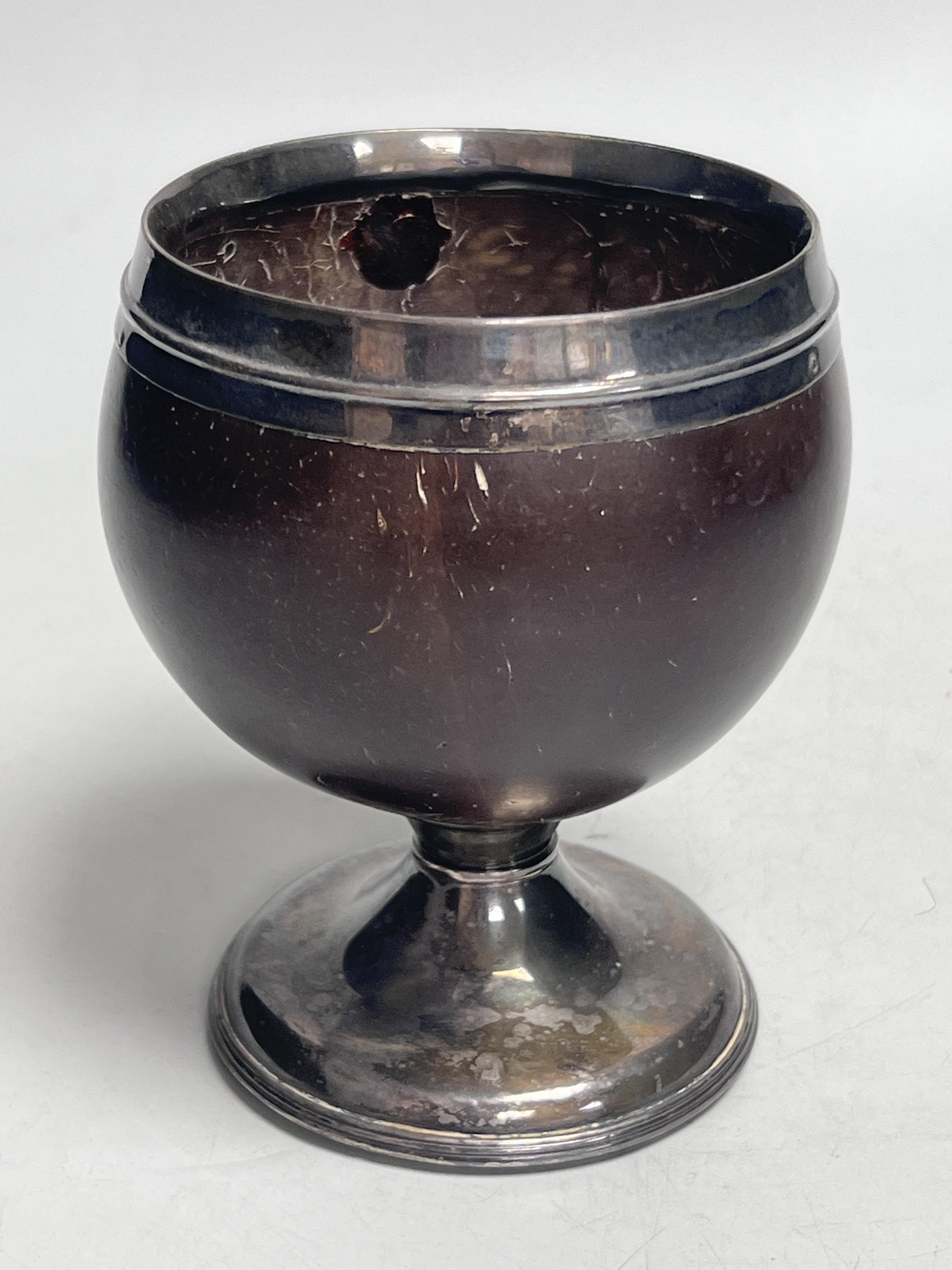 An early 19th century white metal mounted coconut cup, 13cm high